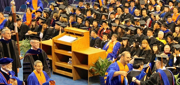 Students sit through a graduation ceremony