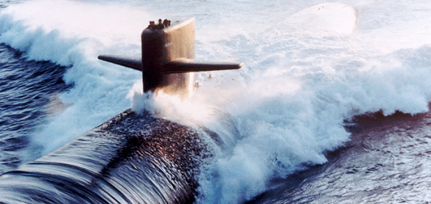 A submarine cuts through ocean waters