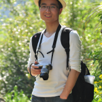Dr. Kai Pan, camera in hand, poses for an outdoor photo