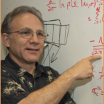 Dr. Paul Gader points to a set of equations on a whiteboard